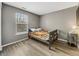 Neutral-toned bedroom with wood floors, window, and simple furnishings at 3708 Magenta Ln # 3, Indianapolis, IN 46214