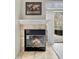 Close-up of the fireplace with detailed mantel and glass doors that enhance the room's charm at 3708 Magenta Ln # 3, Indianapolis, IN 46214