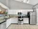 Bright kitchen featuring white cabinets, stainless steel appliances, and tile backsplash at 3708 Magenta Ln # 3, Indianapolis, IN 46214