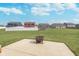 Backyard features a patio, green lawn, and a fire pit for outdoor gatherings and relaxation at 389 Longleaf Ln, Greenfield, IN 46140