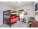 Bright bedroom features a wooden bunk bed, carpeted floor, wooden desk and a ceiling fan at 389 Longleaf Ln, Greenfield, IN 46140