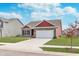 Single-Gathering home with a two-car garage, complemented by a green lawn and blue sky at 389 Longleaf Ln, Greenfield, IN 46140
