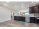 Spacious kitchen with stainless steel appliances and dark cabinetry, open to the living area at 389 Longleaf Ln, Greenfield, IN 46140