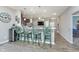 Kitchen bar with stylish seating and modern decor, seamlessly connecting to the dining area at 389 Longleaf Ln, Greenfield, IN 46140