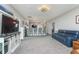 Open-concept living area featuring a plush sofa, breakfast bar, and a cozy atmosphere at 389 Longleaf Ln, Greenfield, IN 46140