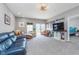 Bright living room with carpet and modern decor, featuring a large TV and comfortable seating at 389 Longleaf Ln, Greenfield, IN 46140