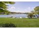 Beautiful backyard view with lush green grass leading to the serene lake at 4615 Crystal Lake Dr, Indianapolis, IN 46240