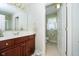 Bathroom with a wood vanity and a view of the toilet in an open doorway at 4615 Crystal Lake Dr, Indianapolis, IN 46240