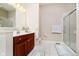 Bathroom with a walk-in shower, sink with cherry wood cabinets, and tile floors at 4615 Crystal Lake Dr, Indianapolis, IN 46240