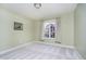Cozy bedroom featuring plush carpet, and a large window with a pleasant view at 4615 Crystal Lake Dr, Indianapolis, IN 46240