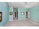 Bright bedroom with light blue walls, carpet, and hallway access at 4615 Crystal Lake Dr, Indianapolis, IN 46240