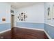 Bedroom with hardwood floors, blue and white walls, and wall decorations at 4615 Crystal Lake Dr, Indianapolis, IN 46240