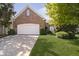 Charming brick home featuring a well-manicured lawn and a two-car garage at 4615 Crystal Lake Dr, Indianapolis, IN 46240
