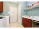 Functional laundry room with a sink, washer, dryer, and ample cabinet storage at 4615 Crystal Lake Dr, Indianapolis, IN 46240