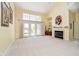 Spacious living room with a fireplace, large windows, and plenty of natural light overlooking the lake at 4615 Crystal Lake Dr, Indianapolis, IN 46240