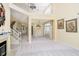 Bright, open living room with two-story ceiling, fireplace, and elegant staircase at 4615 Crystal Lake Dr, Indianapolis, IN 46240