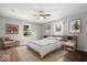 Comfortable bedroom with a ceiling fan, and large windows offering plenty of natural light at 4704 Blue Marlin Way, Indianapolis, IN 46239