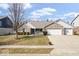 Charming brick home with a well-manicured lawn and a two-car garage at 4704 Blue Marlin Way, Indianapolis, IN 46239