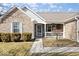 Close up of inviting front porch and landscaped yard of brick home at 4704 Blue Marlin Way, Indianapolis, IN 46239