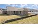 View of the brick home with a well-maintained lawn and back patio at 4704 Blue Marlin Way, Indianapolis, IN 46239