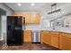 Functional kitchen with black appliances, wood cabinets, and ample counter space at 4704 Blue Marlin Way, Indianapolis, IN 46239
