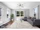 Bright living room with plush seating, ceiling fan, and large windows at 4704 Blue Marlin Way, Indianapolis, IN 46239