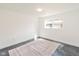 Well-lit bedroom with a sleek floor and a window at 5034 Allisonville Rd # A, Indianapolis, IN 46205