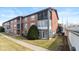 Brick apartment building with sunrooms, balconies, and well-maintained landscaping at 5034 Allisonville Rd # A, Indianapolis, IN 46205