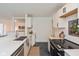 Sleek kitchen with white cabinets, quartz countertops, and a view into the living area at 5034 Allisonville Rd # A, Indianapolis, IN 46205