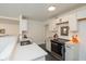 Modern kitchen with white cabinetry, quartz countertops, and stainless steel appliances at 5034 Allisonville Rd # A, Indianapolis, IN 46205