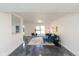 Bright, open living room with polished floors and stylish blue furnishings creating a contemporary feel at 5034 Allisonville Rd # A, Indianapolis, IN 46205