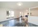 Light-filled living room with large windows, polished floors, and a seamless flow to the kitchen at 5034 Allisonville Rd # A, Indianapolis, IN 46205