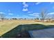 Wide view of backyard overlooking a large field and distant houses at 509 Yorktown Ln, Avon, IN 46123