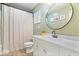 Bathroom featuring a double vanity, round mirror, walk-in shower, and vinyl wood flooring at 5445 Elderberry Rd, Noblesville, IN 46062