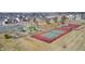 A sunny aerial view of community playground, tennis court, and basketball court in a residential neighborhood at 5524 Goodwin St, Indianapolis, IN 46234