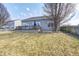 A backyard featuring a wooden deck area, mature trees and a wood fence at 5524 Goodwin St, Indianapolis, IN 46234