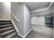Carpeted basement with stairway leading up to the main floor, and a trampoline in the background at 5524 Goodwin St, Indianapolis, IN 46234