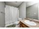 Bathroom with a vanity, toilet, shower with a white curtain, and neutral gray walls and flooring at 5524 Goodwin St, Indianapolis, IN 46234