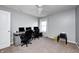 A simple spare bedroom features neutral paint, ceiling fan and large window for natural light at 5524 Goodwin St, Indianapolis, IN 46234