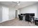 Bedroom with neutral walls, ceiling fan, gray carpet, and a workstation with multiple monitors at 5524 Goodwin St, Indianapolis, IN 46234