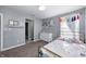 This bedroom features a rainbow theme and a white dresser with decorative shelf above it at 5524 Goodwin St, Indianapolis, IN 46234