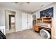Neutral colored bedroom featuring a desk with built-in shelving and view into the room next door at 5524 Goodwin St, Indianapolis, IN 46234