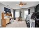 View of a bedroom featuring a star themed accent wall, play tent, and desk with built-in shelving at 5524 Goodwin St, Indianapolis, IN 46234