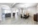 Open-concept dining room featuring hardwood floors, neutral walls and stylish chandelier with easy access to the living room at 5524 Goodwin St, Indianapolis, IN 46234