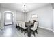 Light and bright dining room features modern chandelier and seating for eight at 5524 Goodwin St, Indianapolis, IN 46234