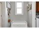Cozy entryway with a white bench, decorative wall art, and ample natural light from a window at 5524 Goodwin St, Indianapolis, IN 46234