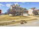 A spacious home featuring a manicured front lawn, brick accents, dormer windows, and a two-car garage at 5524 Goodwin St, Indianapolis, IN 46234