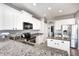 Bright kitchen features granite counters, stainless steel appliances and white cabinets at 5524 Goodwin St, Indianapolis, IN 46234