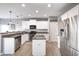 Modern kitchen features stainless steel appliances, granite countertops, white cabinetry and hardwood floors at 5524 Goodwin St, Indianapolis, IN 46234