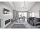 Bright living room featuring vaulted ceilings, hardwood floors, a fireplace, stylish furniture and natural light at 5524 Goodwin St, Indianapolis, IN 46234